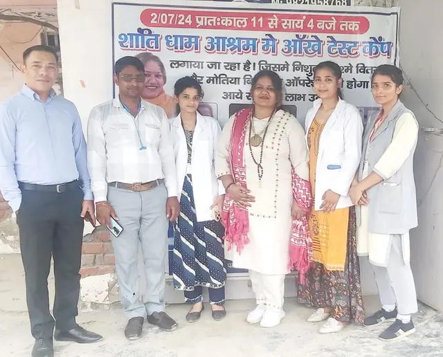 The visiting eye-care team and our members under the camp banner